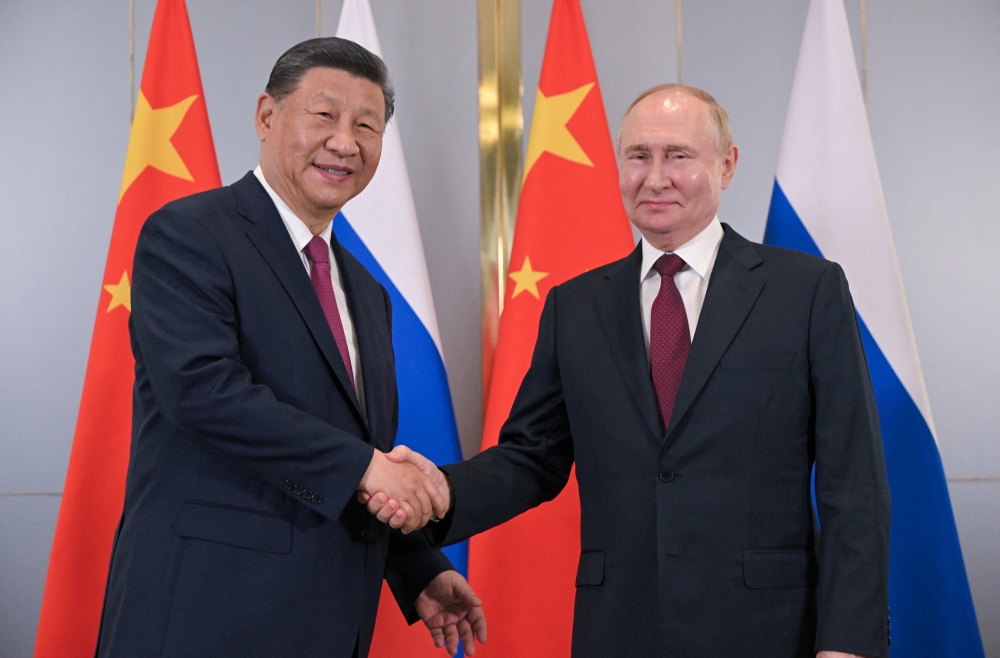 Russian President Vladimir Putin and Chinese President Xi Jinping shake hands during a meeting on the sidelines of the Shanghai Cooperation Organization (SCO) summit in Astana, Kazakhstan July 3, 2024. Sputnik/Sergei Guneev/Pool via REUTERS ATTENTION EDITORS - THIS IMAGE WAS PROVIDED BY A THIRD PARTY.
