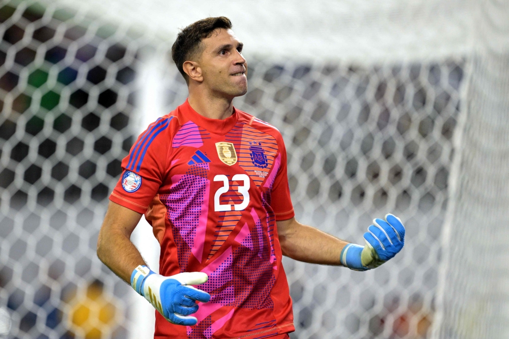 Argentina's goalkeeper Martinez celebrates after saving a penalty kick