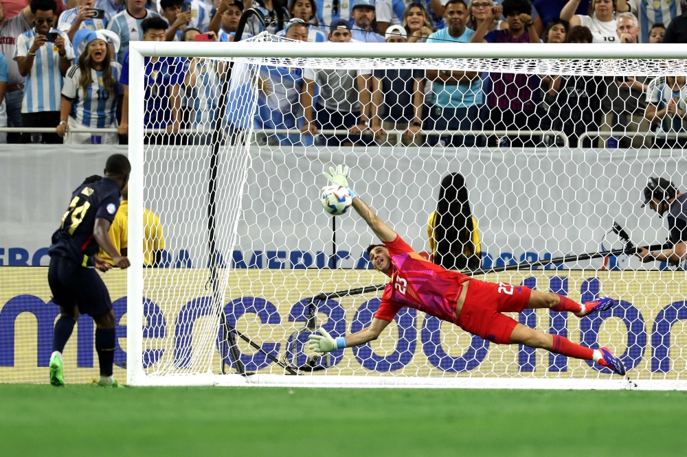 Argentina's goalkeeper Martinez saves a goal from the penalty spot