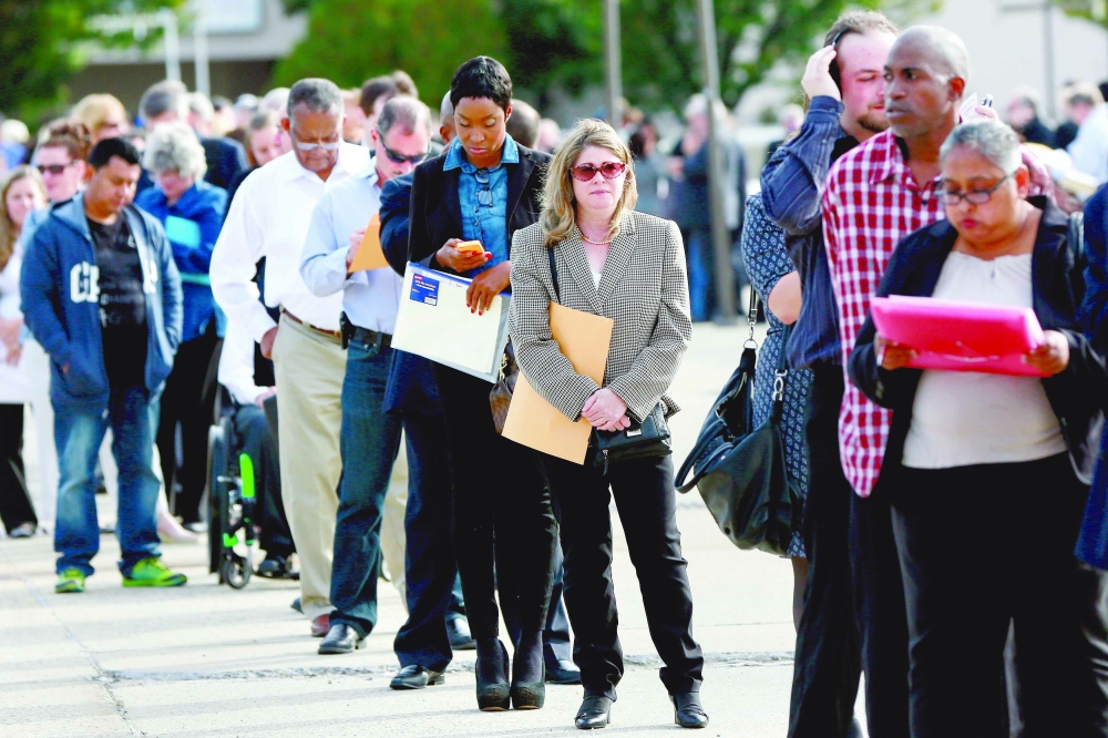People wait in line to enter the Nassau County Mega Job Fair at Nassau Veterans Memorial Coliseum in Uniondale, New York. — Reuters