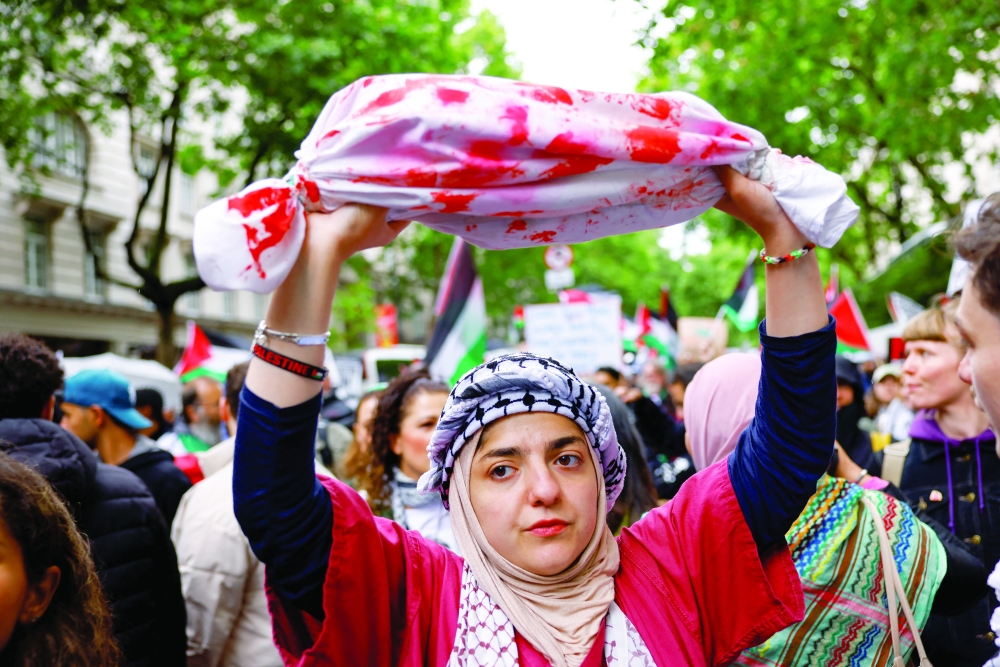 A demonstrator during a protest in solidarity with Palestinians in Gaza, amid the ongoing conflict between Israel and Hamas, in London, Britain, on Saturday. - Reuters