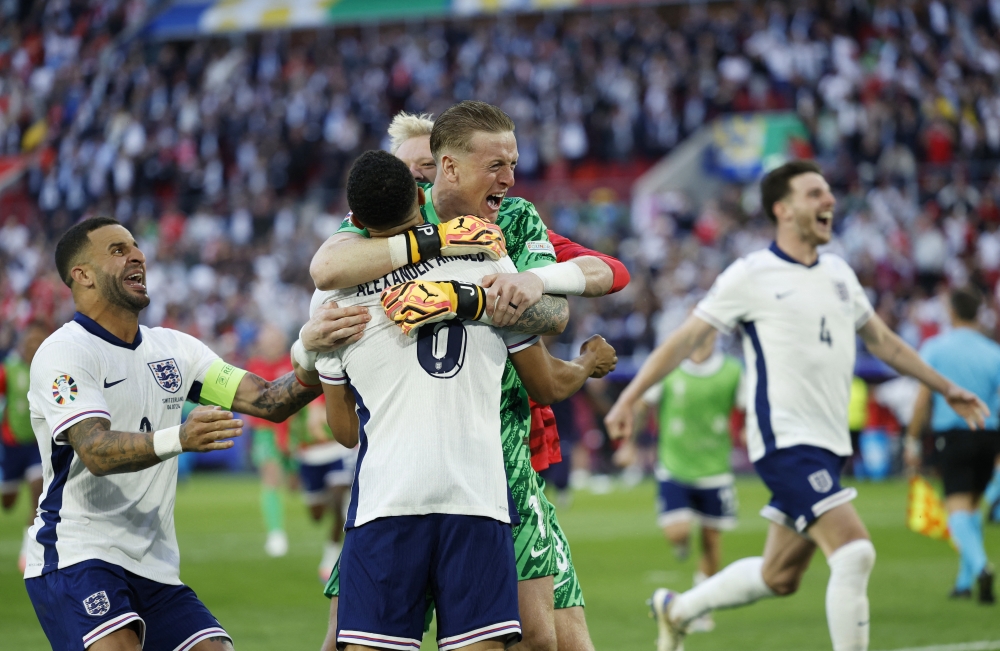 Trent Alexander-Arnold and Jordan Pickford celebrate after winning the penalty shootout.