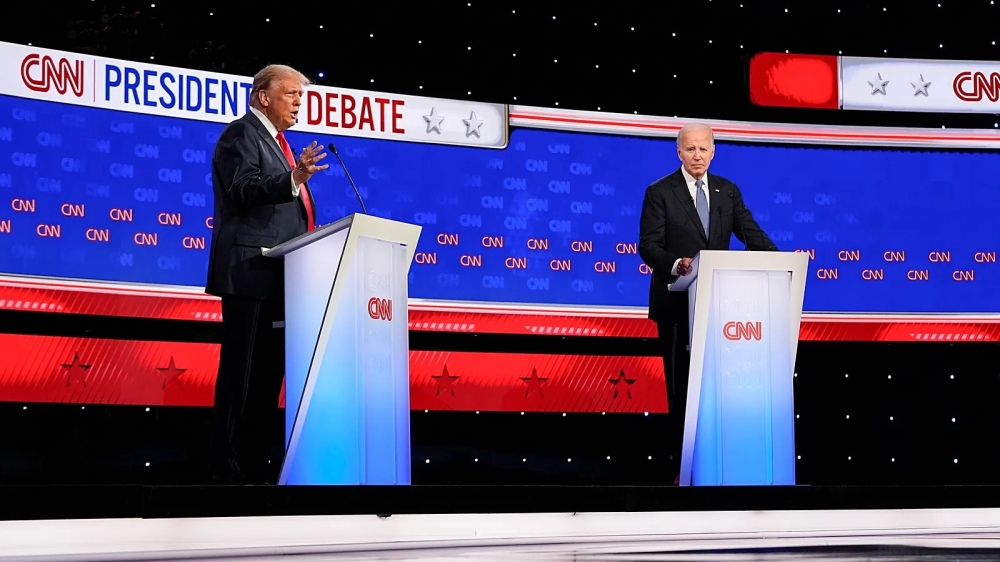 President Joe Biden, right, listens as Republican presidential candidate former President Donald Trump speaks during a presidential debate hosted by CNN, in Atlanta. — AFP