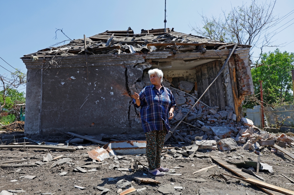 Local resident Irina Kuleshova, 66, stands in front of her house damaged by recent shelling, n the town of Yasynuvata. — Reuters 