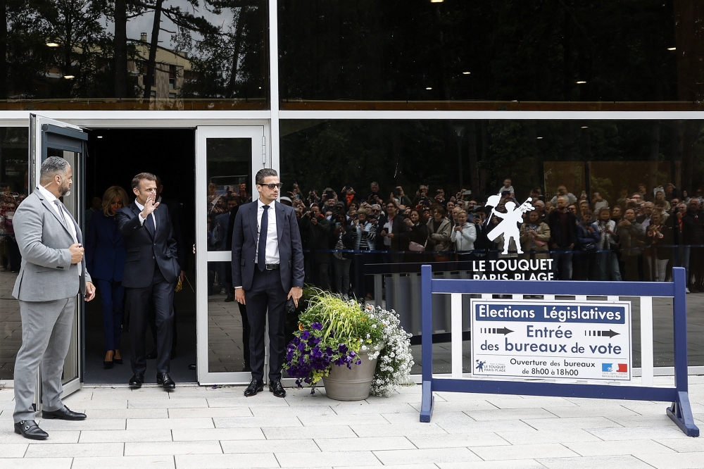French President Emmanuel Macron and French First Lady Brigitte Macron exit the polling station after casting their votes in the second round of French parliamentary elections in Le Touquet-Paris-Plage. — Reuters 