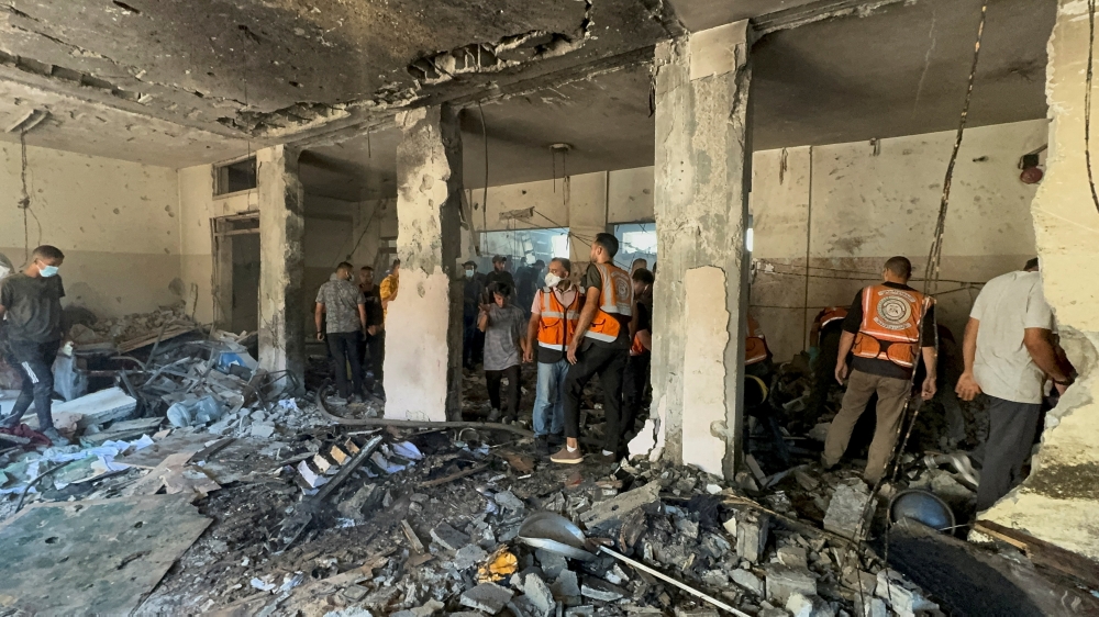 Palestinians inspect the Holy Family School which shelters displaced people, after it was hit in an Israeli strike. — Reuters