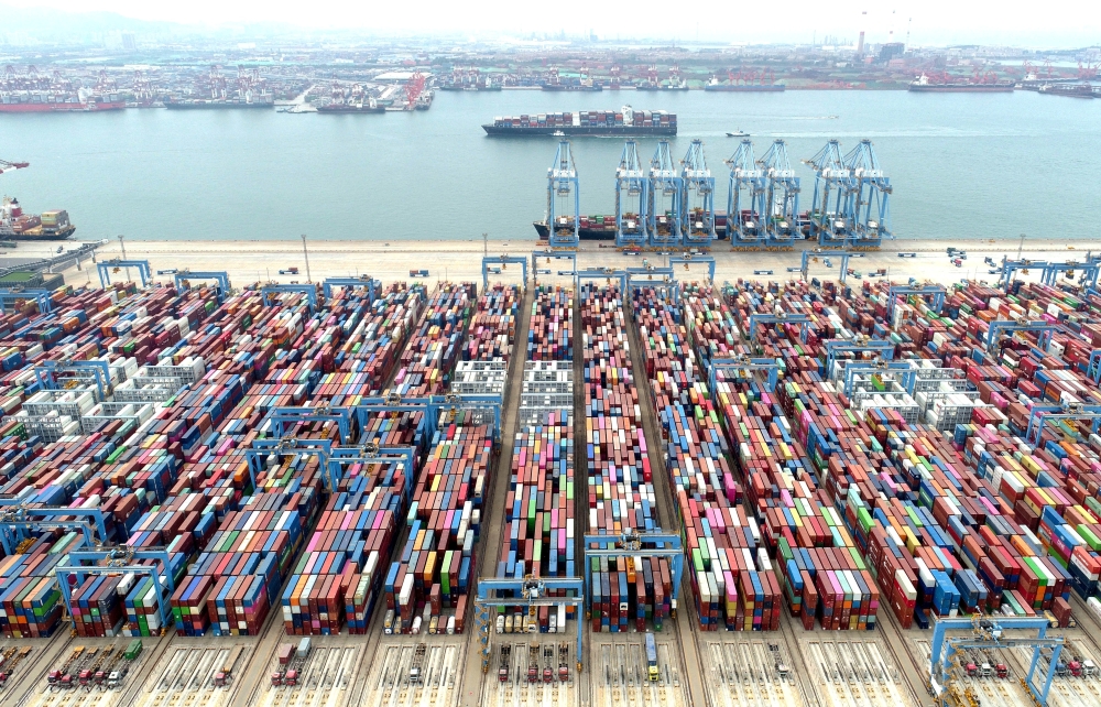An aerial view shows containers and cargo vessels at the Qingdao port in Shandong province, China.— Reuters