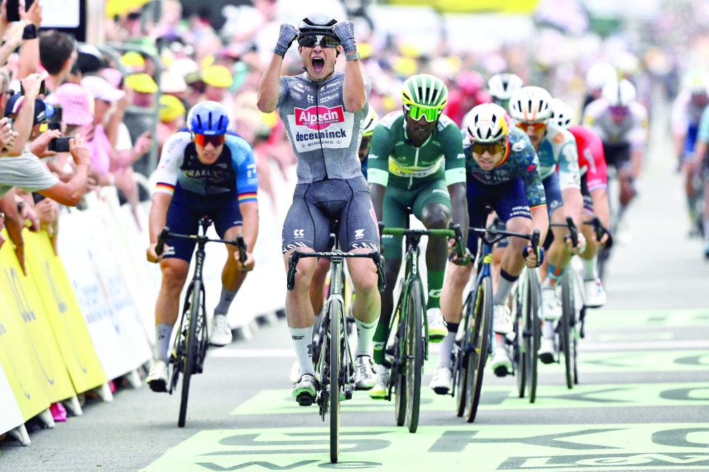 Belgian rider Jasper Philipsen (C) cycles past the finish line.— AFP

