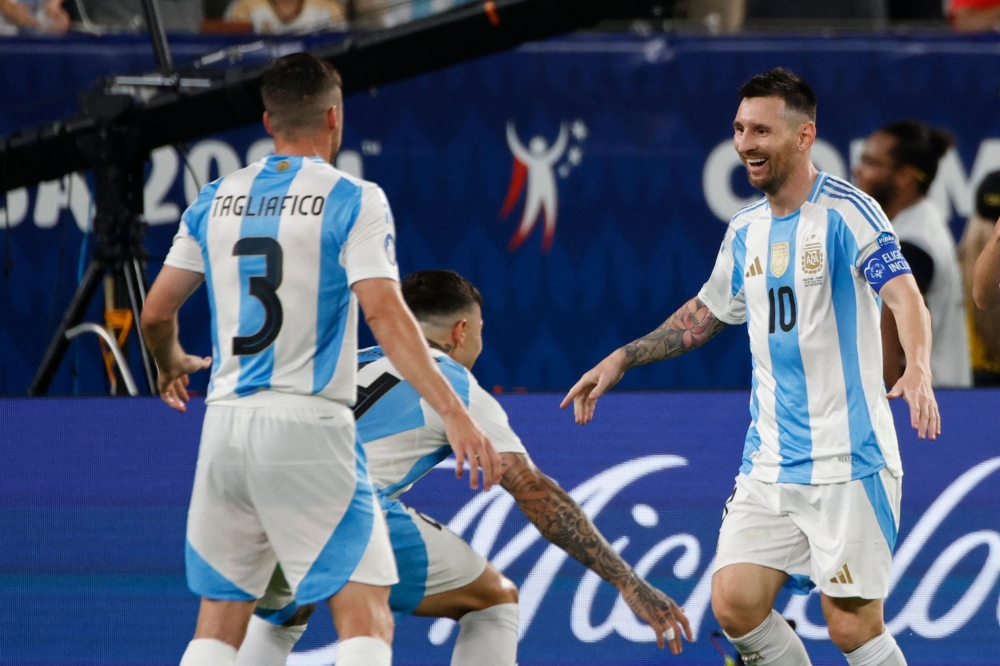 Lionel Messi (R) celebrates with teammates after scoring second goal. — AFP

