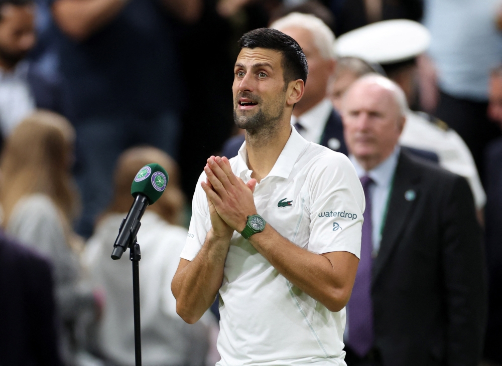 Serbia's Novak Djokovic gives a speech after winning against Holger. — Reuters