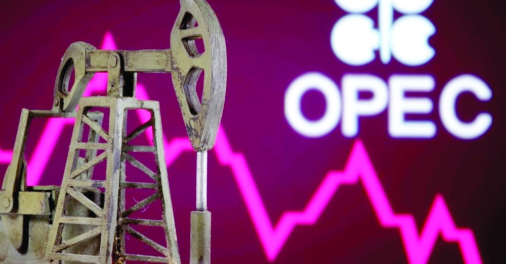 A 3D printed oil pump jack is seen in front of displayed stock graph and Opec logo in this illustration picture. — Reuters