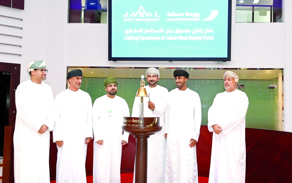 Abdulaziz Ali al Muqbali (2nd, right), board member of Jabal Asset Management, rings the bell to celebrate the listing of Jabal Real Estate Investment Fund at the Muscat Stock Exchange. 