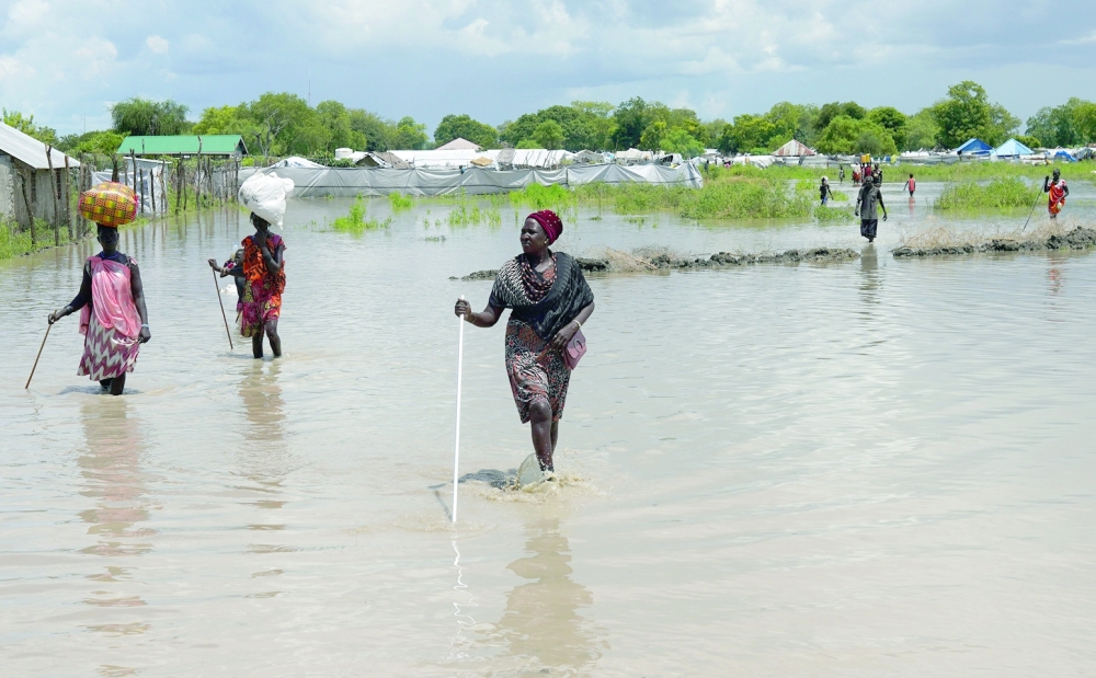 Women wade through flood waters after the River Nile broke the dykes in Pibor, Greater Pibor Administrative Area, South Sudan. — Reuters file photo