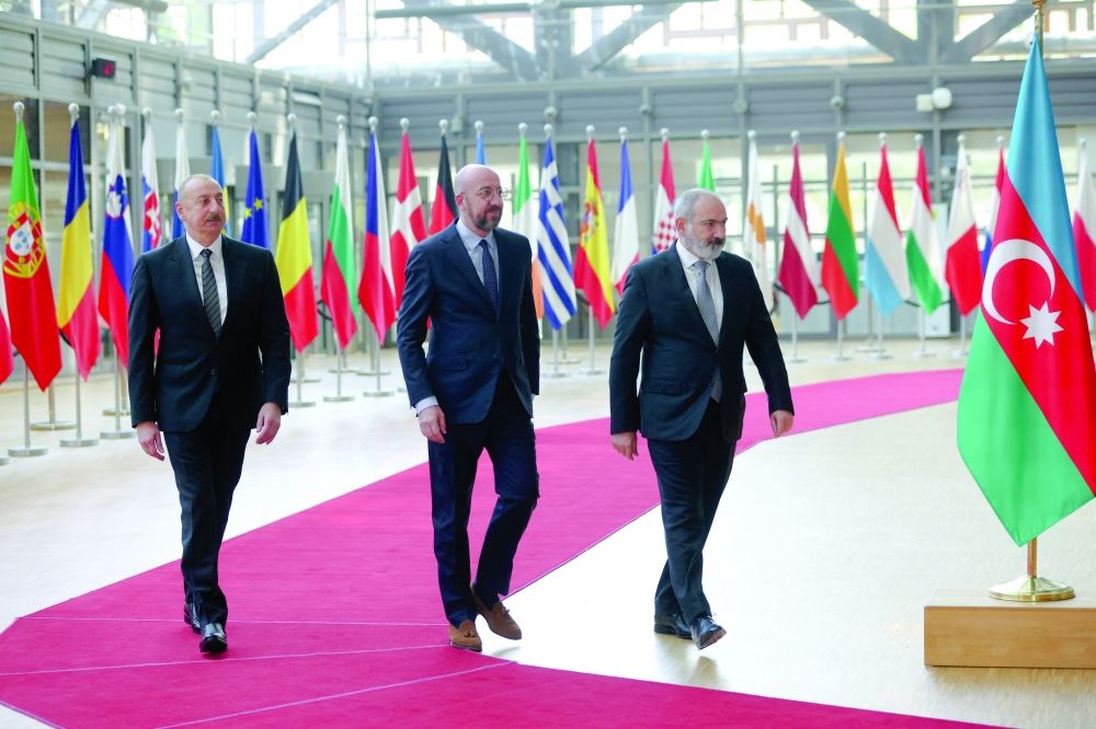 Azerbaijan's President Ilham Aliyev and Armenian Prime Minister Nikol Pashinyan are welcomed by European Council President Charles Michel in Brussels. — Reuters file photo 