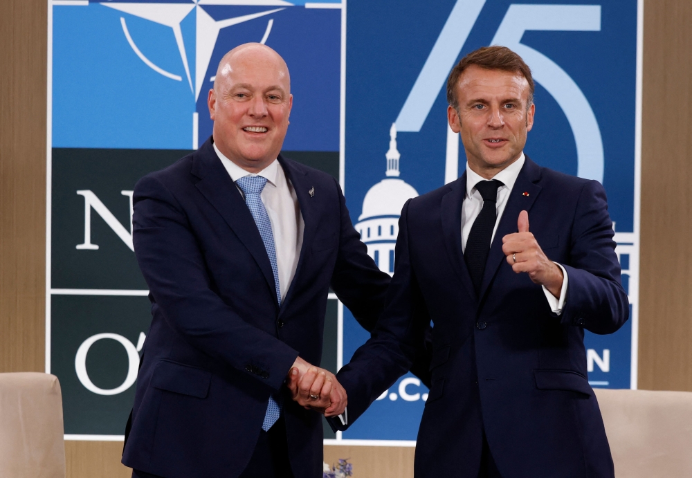 French President Emmanuel Macron gives a thumbs up as he shakes hands with New Zealand Prime Minister Christopher Luxon prior to a meeting on the sidelines of the Nato 75th anniversary summit in Washington, DC. - AFP

