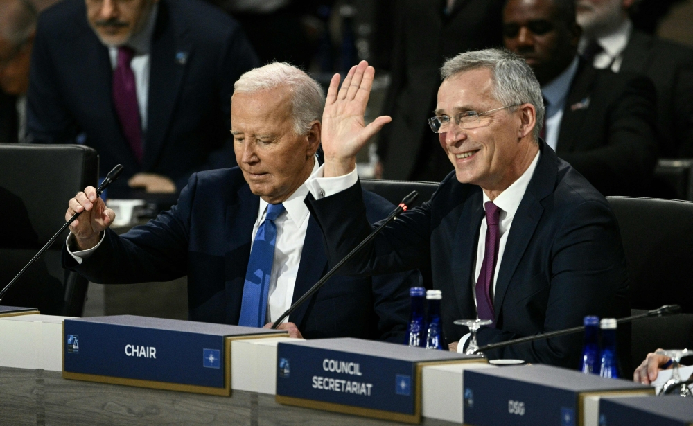 US President Joe Biden (L) and NATO Secretary General Jens Stoltenberg participate in Working Session of the NATO Summit at the Walter E. Washington Convention Center in Washington, DC, July 11, 2024. (Photo by Brendan SMIALOWSKI / AFP)