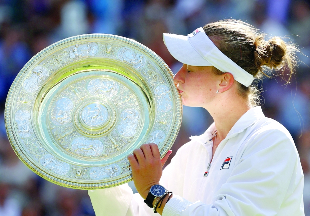 Barbora Krejcikova kisses the Venus Rosewater Dish trophy. — Reuters