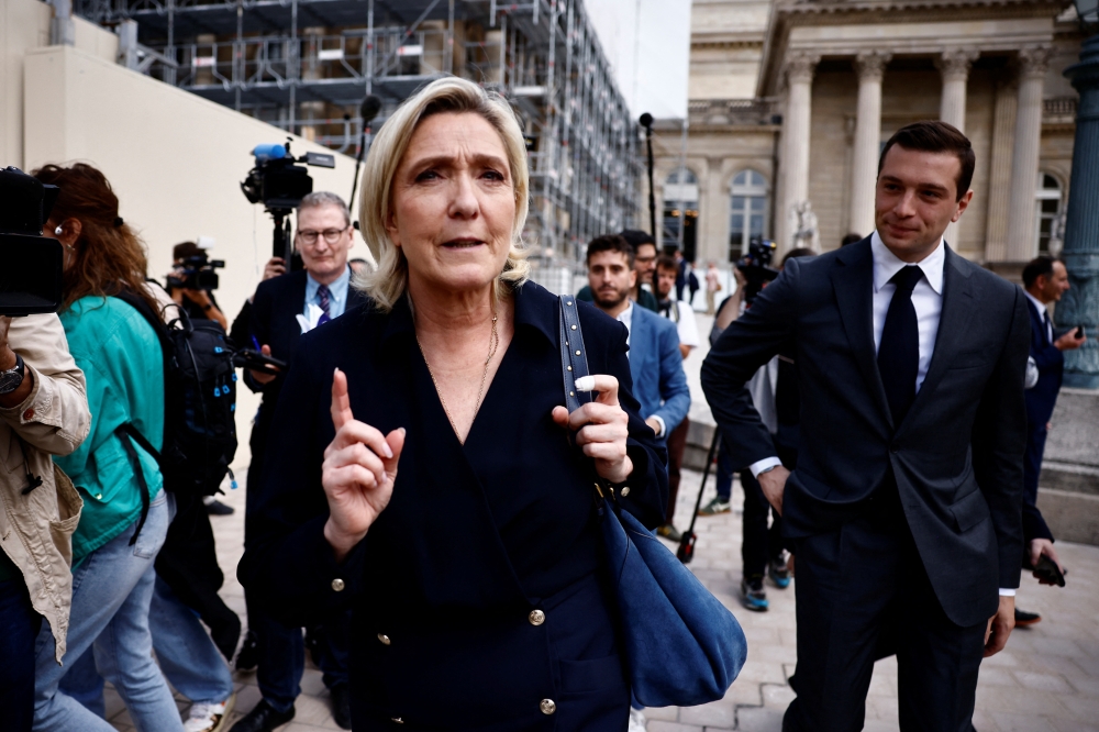 French far-right leader Marine Le Pen, member of parliament of the Rassemblement National (National Rally - RN) party, is surrounded by journalists at the National Assembly in Paris after the second round of the early French parliamentary elections, France. - Reuters

