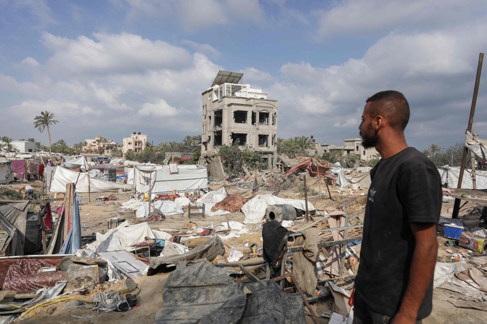 A Palestinian man looks at damaged tents at the site of Israeli bombardment on the al-Mawasi displacement camp. — AFP 