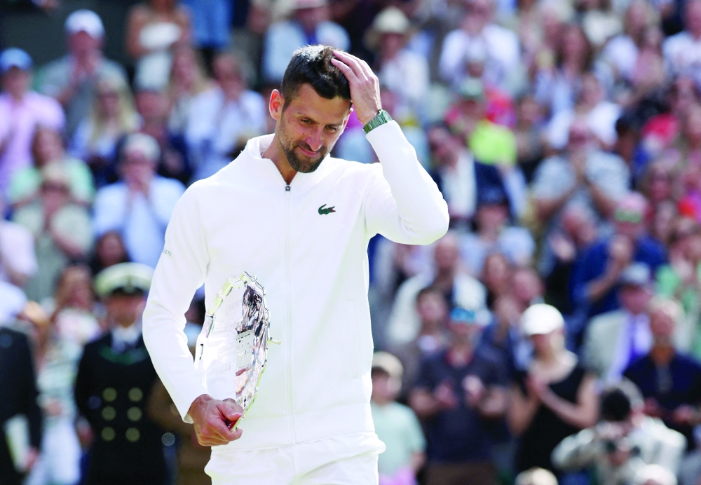 Novak Djokovic holds his runner up trophy. — Reuters
