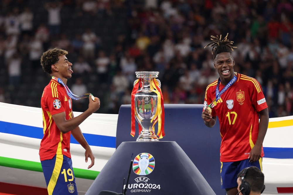 Spain's Lamine Yamal and Nico Williams celebrate after winning. —   Reuters