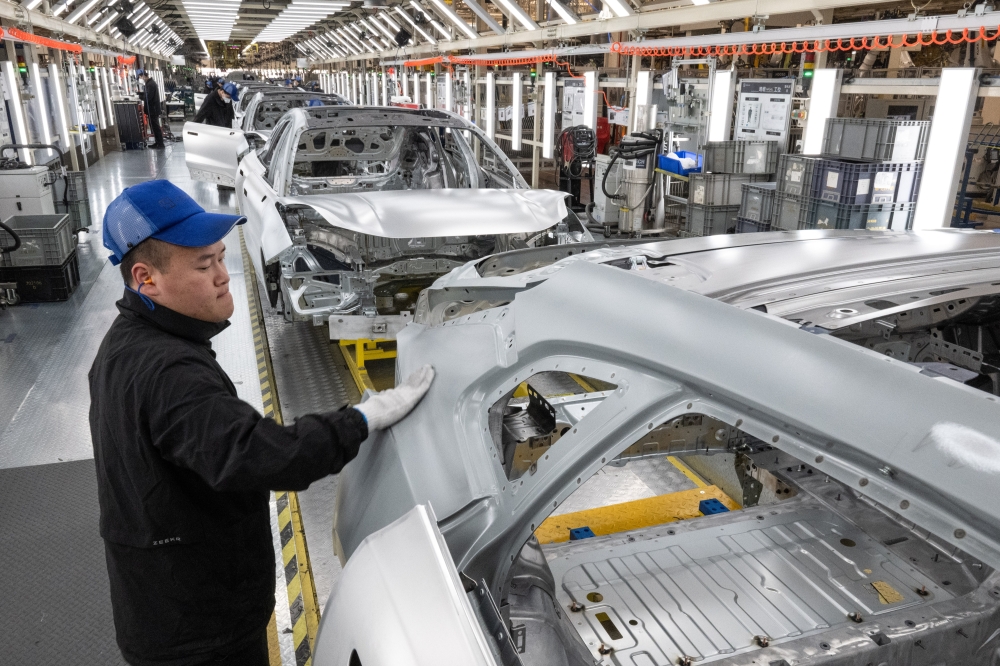 An assembly line for Chinese electric vehicle (EV) maker Zeekr at a plant in Hangzhou Bay, China. —The New York Times)