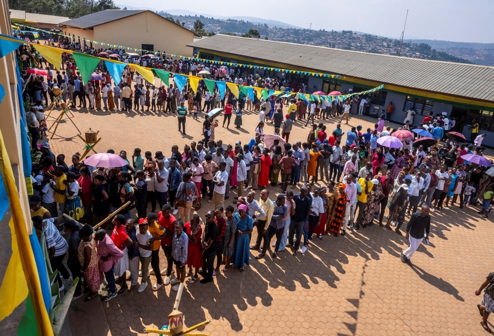 People queue before casting their ballots during the presidential election at the GS Kagugu polling centre, in Kinyinya, July 15. — Reuters 
