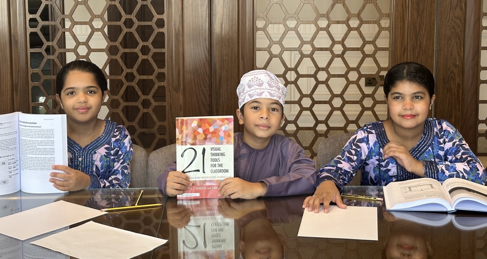 Makarim, Sultan and Mafakhir Al Busaid with the holding the book Visual thinking tool for the classroom