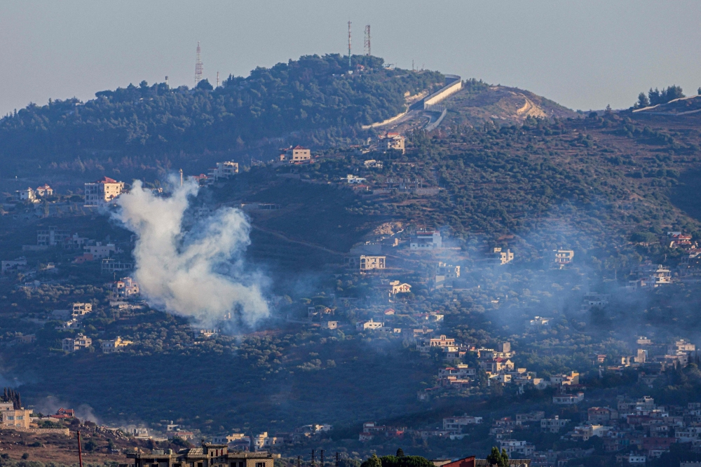  Smoke billows following an Israeli strike near the village of Kfar Kila in southern Lebanon. — AFP 