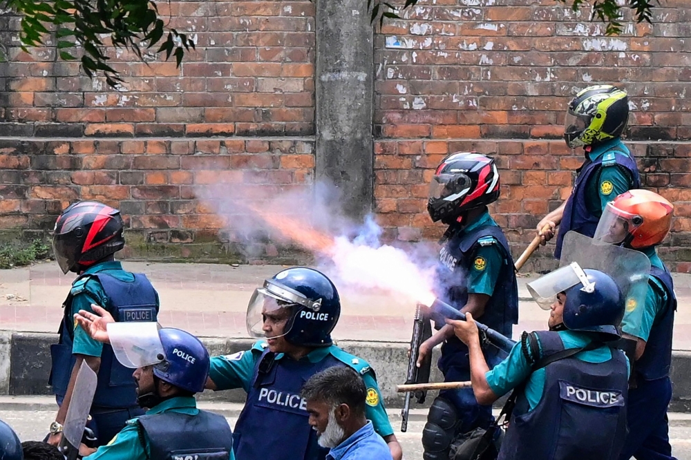 Bangladesh police fire tear shells to disperse anti-quota protesters during a clash in Dhaka. - AFP 