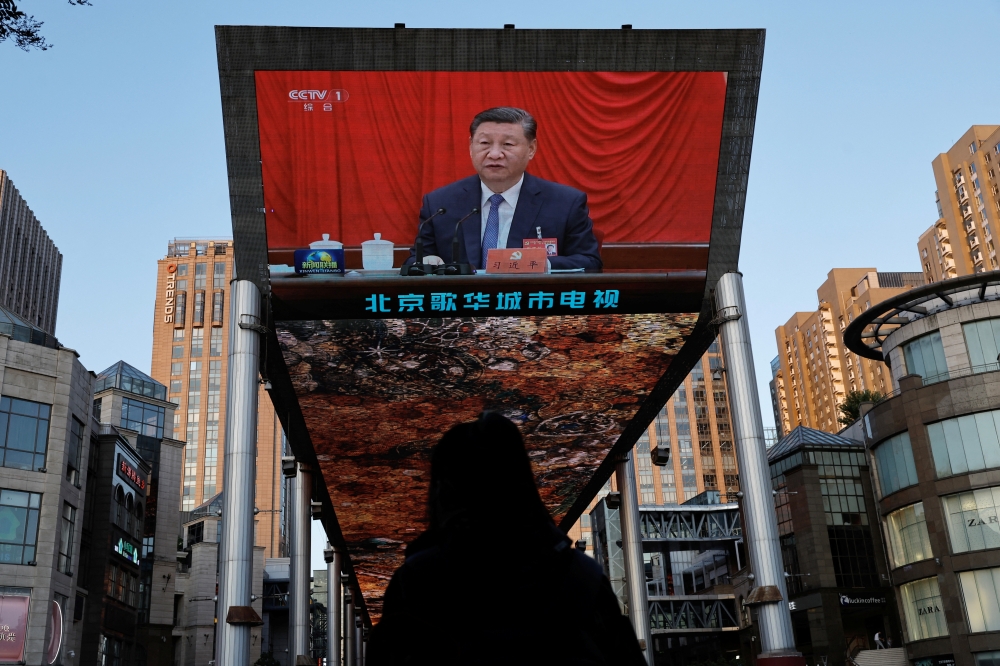 A giant screen shows news footage of Chinese President Xi Jinping attending the third plenary session of the 20th Central Committee of the Communist Party of China (CPC), in Beijing. - Reuters
