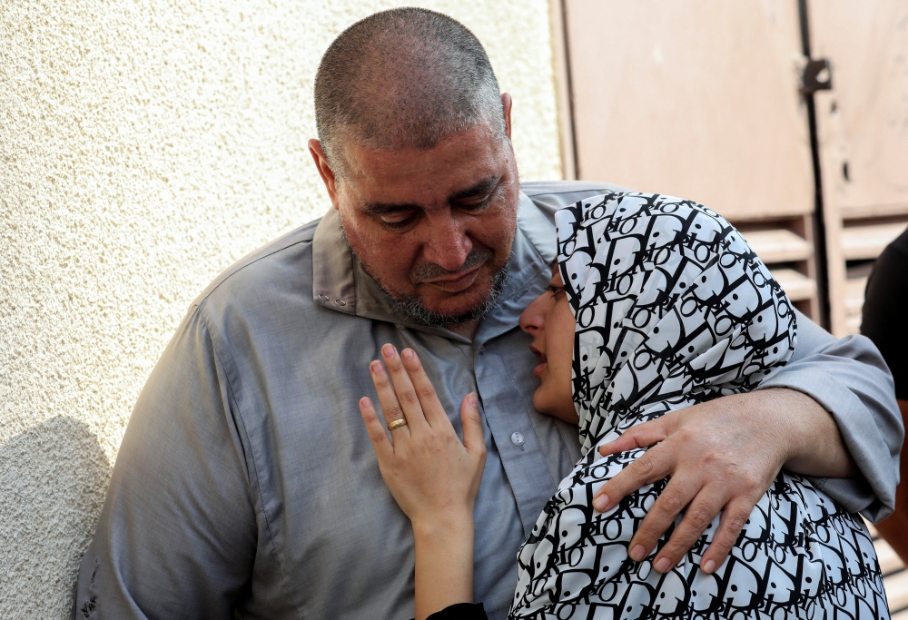 Palestinians mourn a relative killed in an Israeli strike at Al Aqsa Martyrs Hospital in Deir Al Balah in the central Gaza Strip. - Reuters
