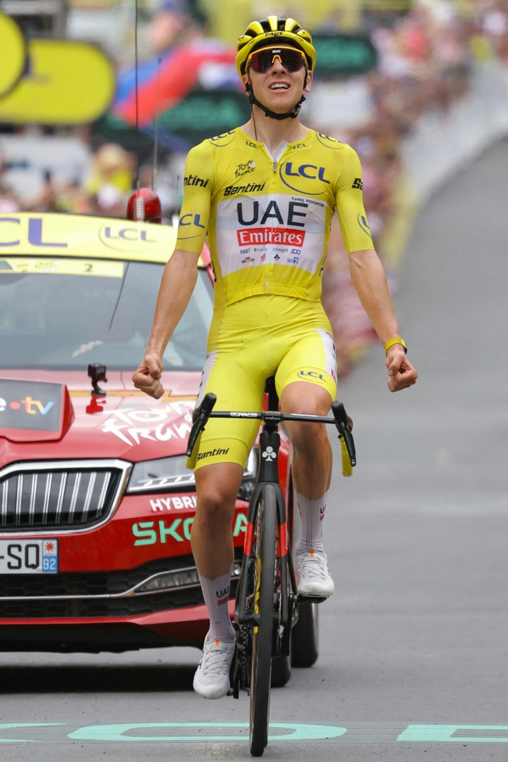 Tadej Pogacar cycles to the finish line. — AFP