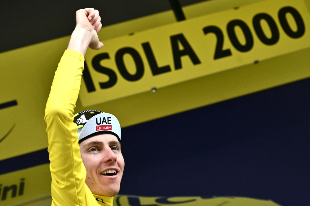 Tadej Pogacar cycles to the finish line. — AFP