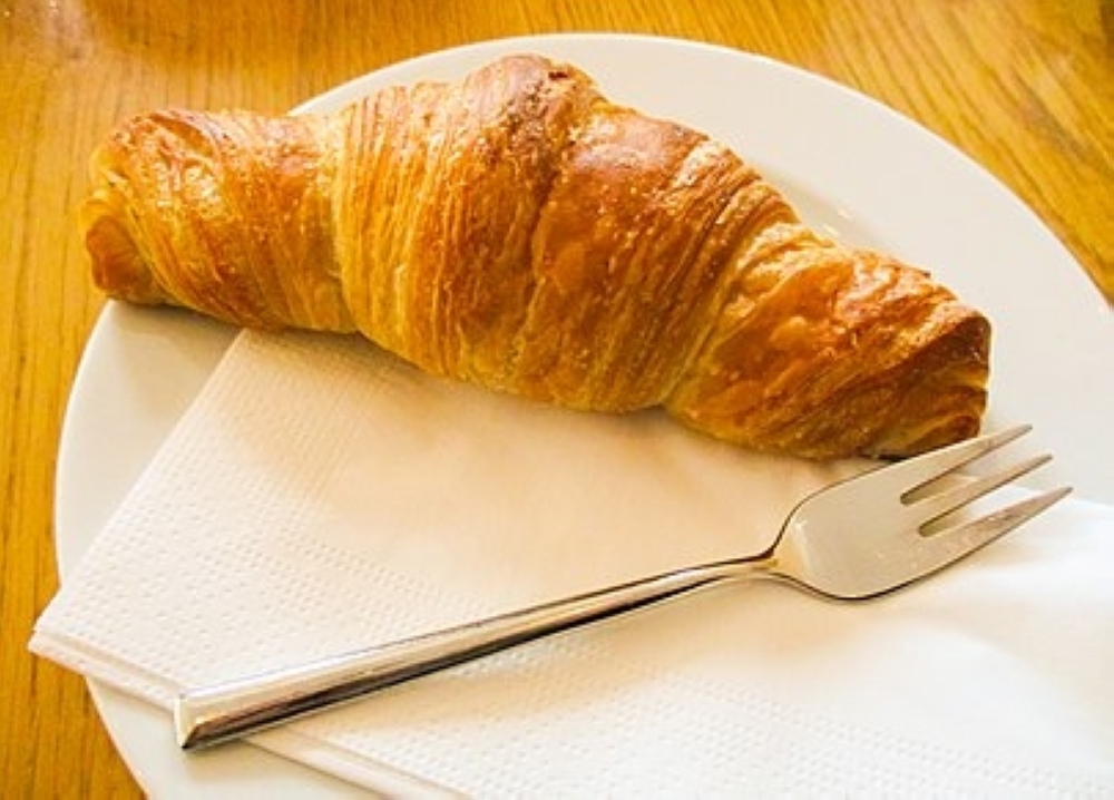 A crescent-shaped bread arrived with Austrian bakers at the 1889 Paris Exposition, but the croissant stepped into its full power a few decades later, when French bakers started shaping it using a laminated dough.
