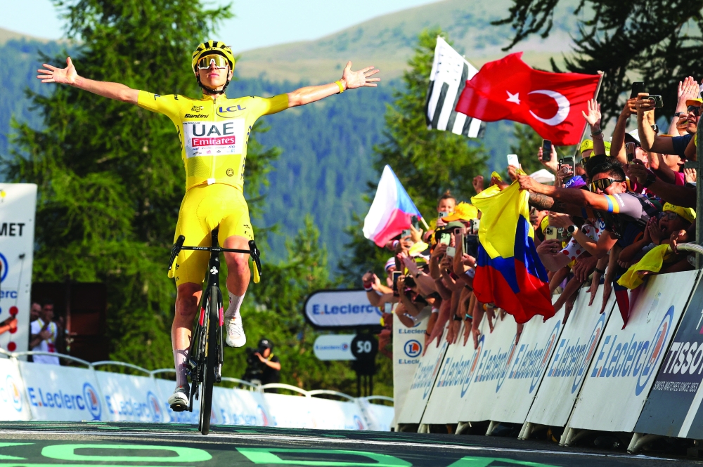 Tadej Pogacar with yellow jersey celebrates after winning. — Reuters