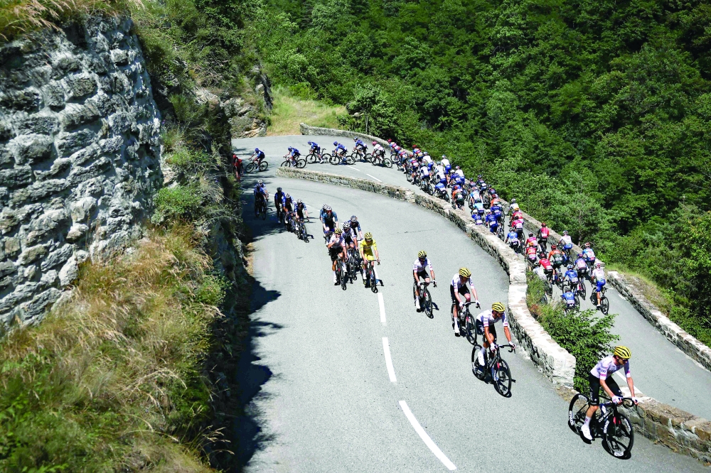 Tadej Pogacar wearing the overall leader's yellow jersey. — AFP