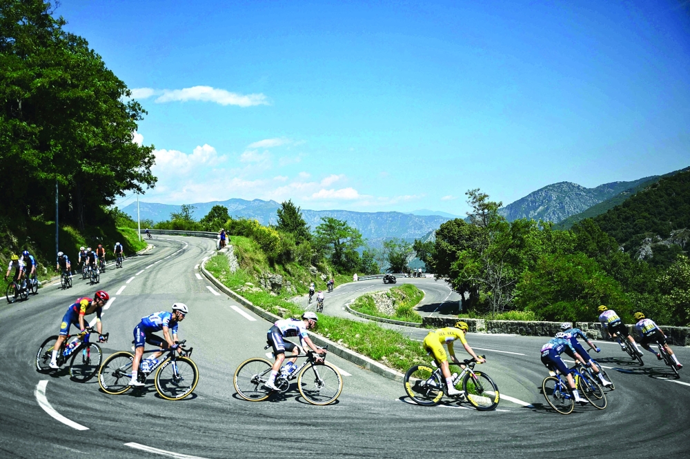 Tadej Pogacar wearing the overall leader's yellow jersey. — AFP