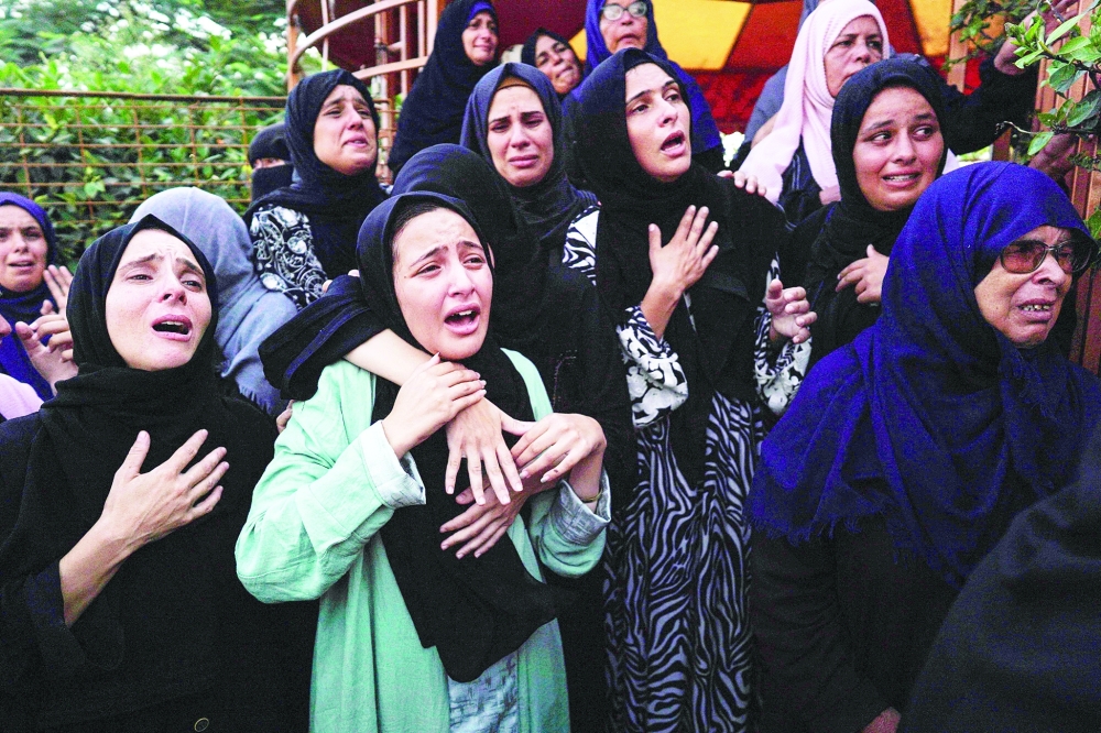 Relatives mourn members of the Qadih family in front of the morgue of the Nasser hospital in Khan Yunis. — AFP