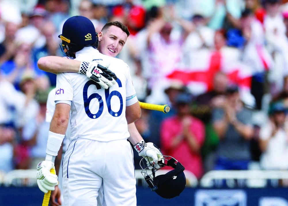 England's Harry Brook celebrates with Joe Root after. — Reuters