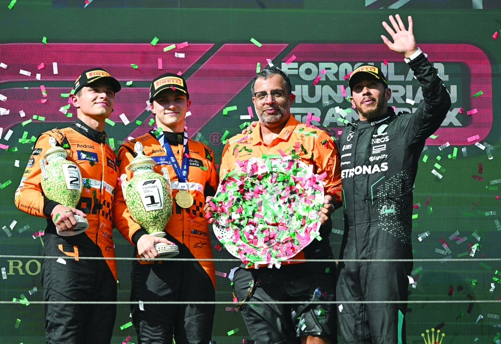 (LtoR) second winner Lando Norris, Oscar Piastri,  third winner Lewis Hamilton. — AFP