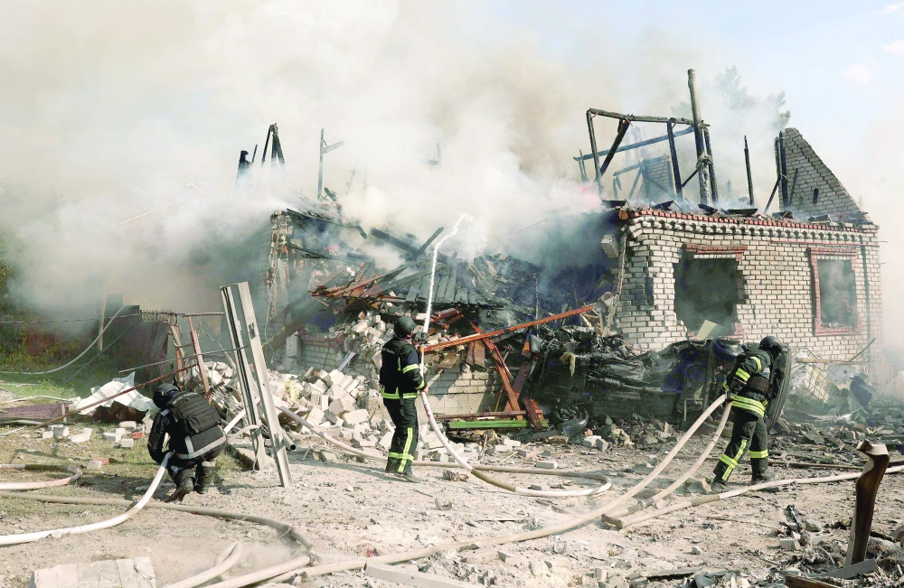 Rescuers put out a fire in a private house destroyed during a missile attack, Donetsk, Ukraine. 