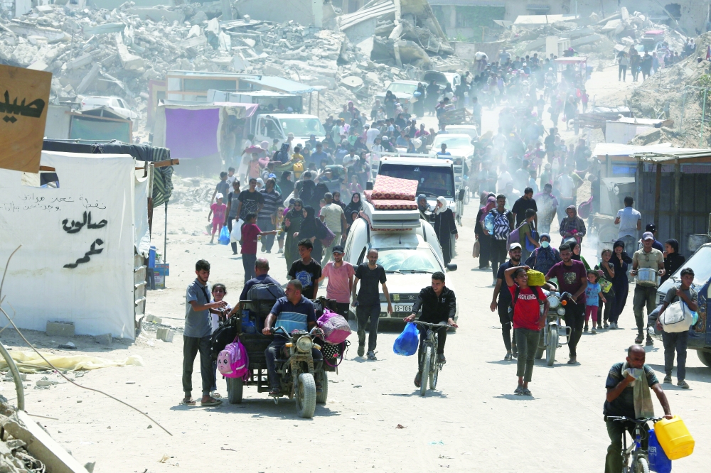 Palestinians flee the eastern part of Khan Younis as they make their way following Israeli army orders to evacuate their neighborhoods. — Reuters 