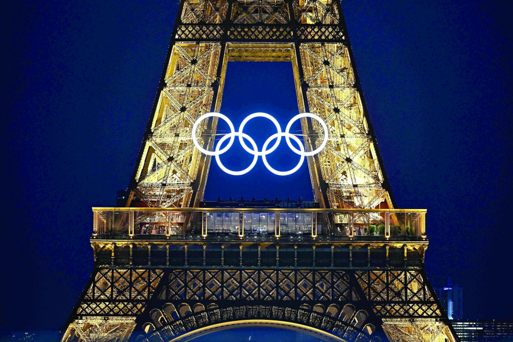 Eiffel Tower bearing the Olympics rings. — AFP