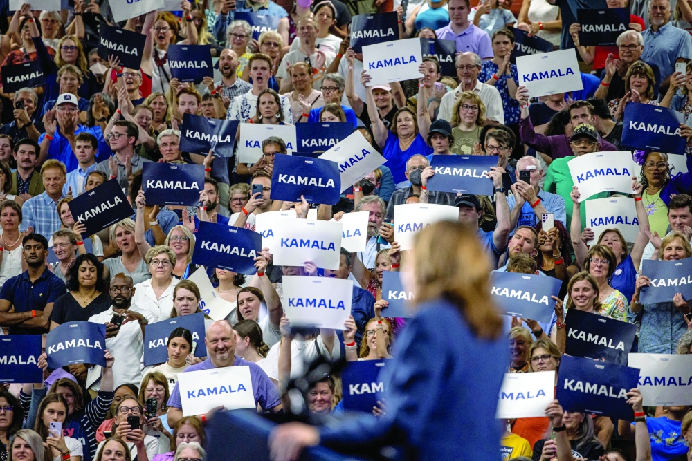 People raise signs in support of U.S. Vice President Kamala Harris as she speaks at a campaign event, Wisconsin, U.S. — Reuters 
