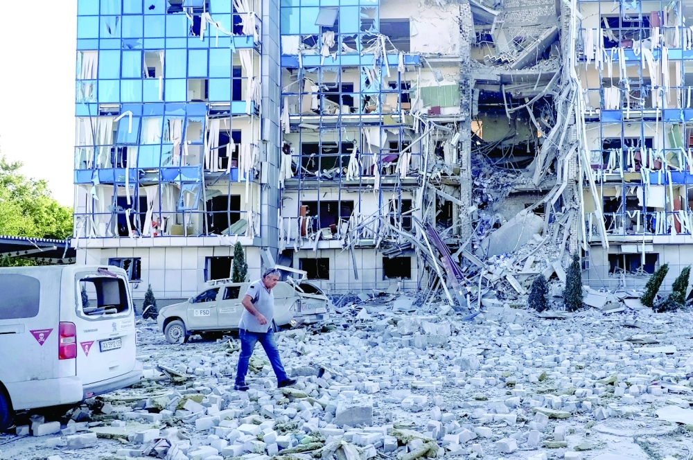 A man walks next to an office building of FSD (Fondation Suisse de Déminage), damaged during a Russian missile attack, in Mykolaiv, Ukraine. — Reuters 
