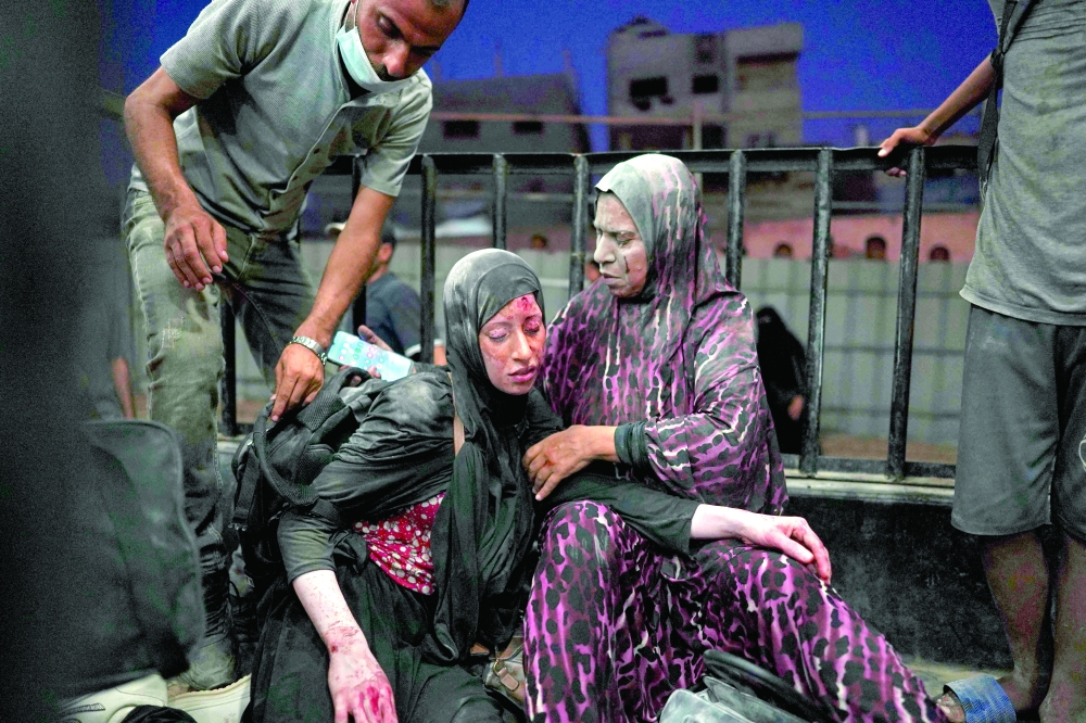 Women injured during Israeli bombardment arrive at the emergency ward at al-Nassr hospital in Khan Yunis. — AFP 
