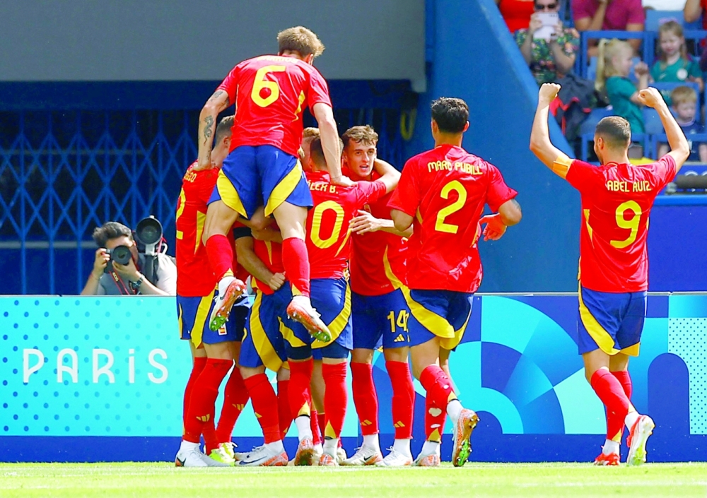 Spain players celebrate scores their second goal.— Reuters
