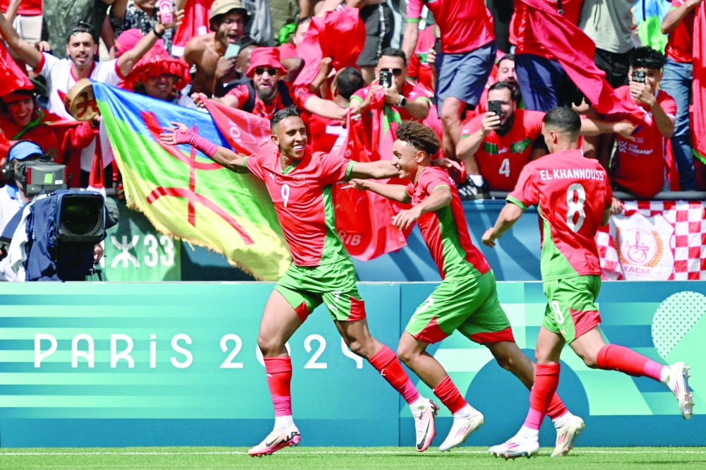 Morocco's Soufiane Rahimi (L) celebrates with Eliesse Ben Seghir (C) and Bilal El Khannouss. — AFP