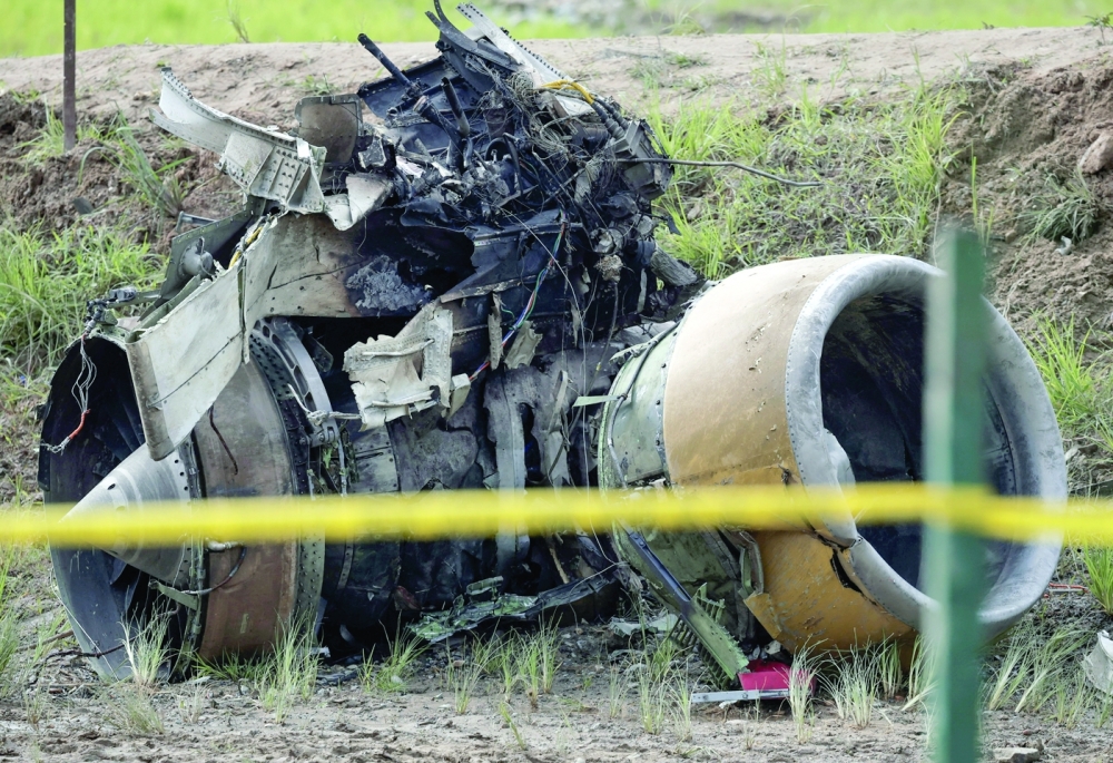 A jet engine of a Saurya Airlines plane that caught fire after skidding off the runway while taking off at Tribhuvan International Airport lies at the crash site in Kathmandu. - Reuters
